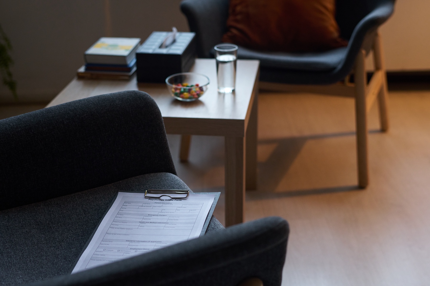 A quiet corner of the practice with an intake form on an armchair
